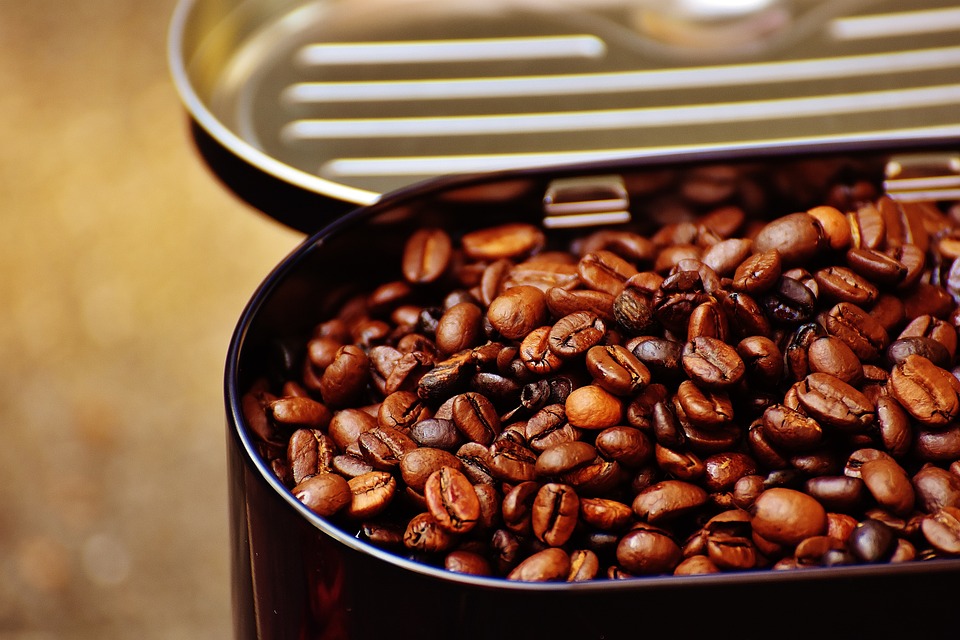 Close view of coffee beans inside of a canister. | Coffee shops around Little Rock, AR.